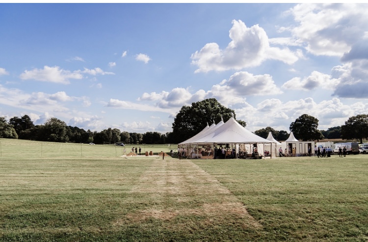 Large Sperry style tent. Beautiful large sailcloth tent for a wedding for 200 guests. Sides rolled up on the marquee for the summers day.