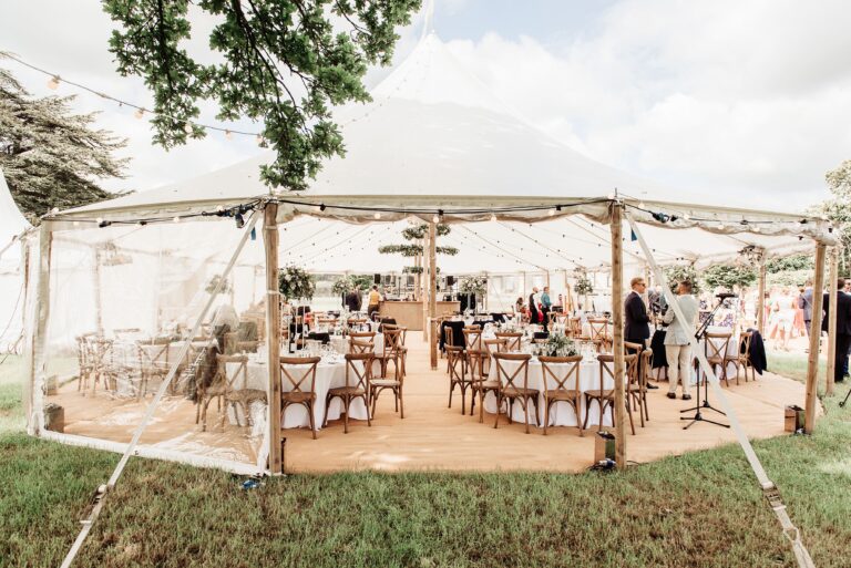 interior sailcloth tent round tables and chairs for a wedding